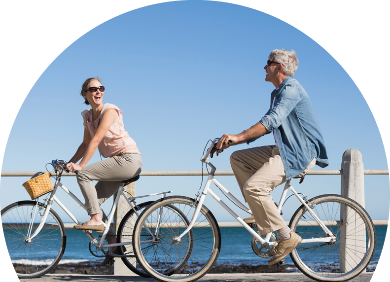 Woman and man riding bicycles laughing