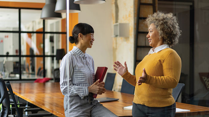 Two woman taking at a meeting room
